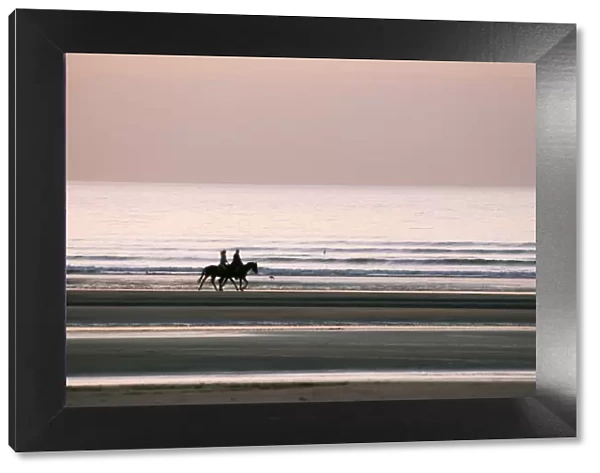 Horse Horseback riding on beach by sunset, Deauville, France