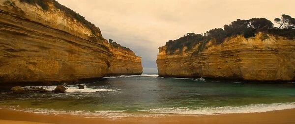 Loch Ard Gorge - view of sandstone cliffs at Loch Ard Gorge from beach. The force of the sea eats more and more of the rocks away and finally forces them to collapse - Port Campbell National Park, Great Ocean Road, Victoria, Australia
