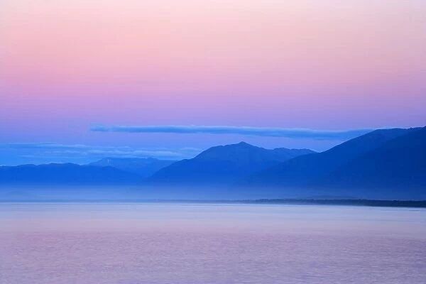 Twilight ocean and mountains around Jackson Bay at twilight after sunset Jackson Bay, Haast, South Island, New Zealand