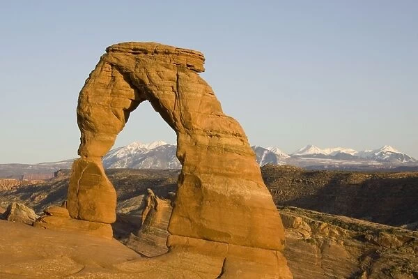 USA - Delicate Arch probably is the most famous sandstone rock sculpture in the Arches National Park. In the background the snow-capped La Sal Mountains. Photographed in spring (April). Arches National Park, Utah, USA