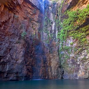 Emma Gorge Waterfall - water plunges down a steep cliff into a picturesque plunge pool in Emma Gorge which is located along the famous Gibb River Road in the El Questro Wilderness Area