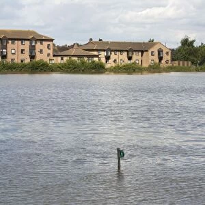 New houses built on flood plain with submerged footpath sign Newtown - Tewkesbury - Gloucestershire - UK following unprecedented flooding of Rivers Severn and Avon July 2007