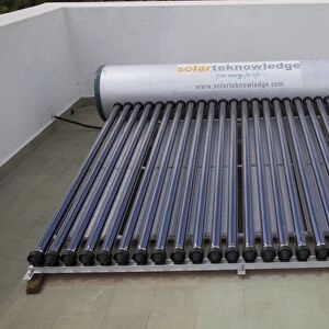 Solar thermal water heating system with tank and evacuated tubes on roof of house - Mombasa - Kenya