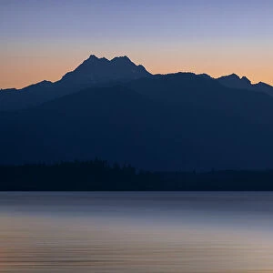 USA, Washington State, Seabeck. Crescent moon at sunset over Hood Canal and Olympic Mountains. Date: 13-07-2021
