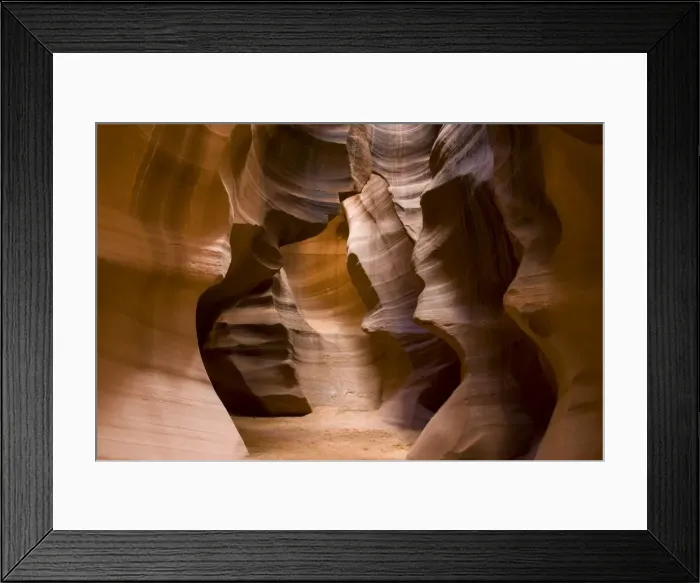 Framed Print : USA - Light that penetrates into the narrow canyon walls creates beautiful hues on the graceful curves of sandstone rock in the Upper Antelope Canyon, probably the most famous slot canyon in the Southwest. Antelope Canyon