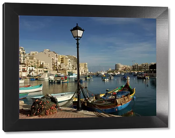 Malta - Spinola Bay - once a thriving fishing port, but in recent years tourism has taken over. The brighly coloured traditional Maltese fishing boats are called 'Luzzu'. November