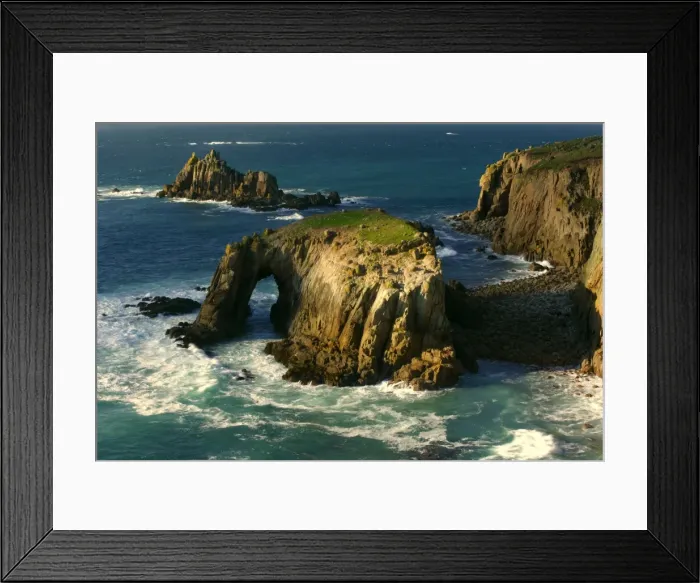 Framed Print : Lands End rugged coastline with rock arch in last evening light Lands End, Cornwall, England, UK
