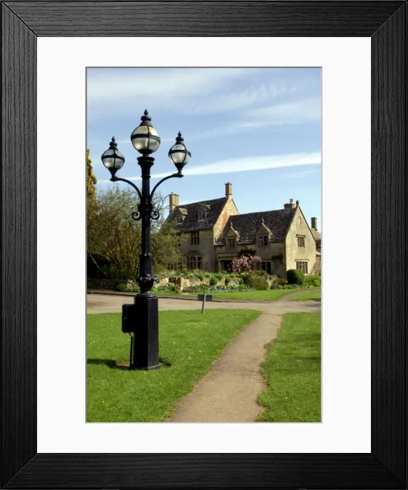 Framed Print : England - A Cotswold village thoroughfare on a Spring morning. April. Cotswolds, UK Framed Print : England - A Cotswold village thoroughfare on a Spring morning. April. Cotswolds, UK