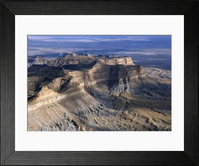 Framed Print : Aerial view of the Book Cliffs - north of the town of Green River, Utah; looking south towards Green River. The cliffs are carved into the Mancos Shale (marine deposits, grey talus slope), capped by sandstone of the Mesaverde Group Framed Print : Aerial view of the Book Cliffs - north of the town of Green River, Utah; looking south towards Green River. The cliffs are carved into the Mancos Shale (marine deposits, grey talus slope), capped by sandstone of the Mesaverde Group