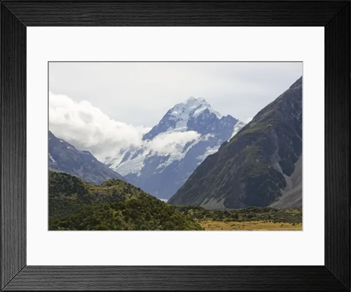 Framed Print : New Zealand - spectacular scenery of glacial valley with snow capped mountains and forested slopes in Aoraki Mount Cook National Park. Surrounded by snow covered mountains this spectacular wilderness area in South Island New Zealand ihas now been Framed Print : New Zealand - spectacular scenery of glacial valley with snow capped mountains and forested slopes in Aoraki Mount Cook National Park. Surrounded by snow covered mountains this spectacular wilderness area in South Island New Zealand ihas now been