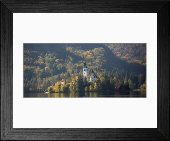 Framed Print : Lake Bled. 14th - 17th century church on island in the lake, with autumn woodland colours on the mountainside beyond. Slovenia Framed Print : Lake Bled. 14th - 17th century church on island in the lake, with autumn woodland colours on the mountainside beyond. Slovenia