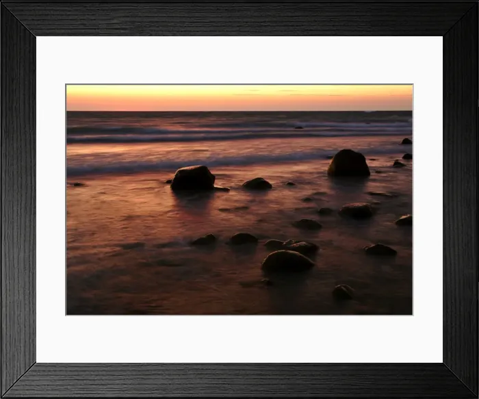 Framed Print : Sunrise at sea beach with boulders and approaching waves Moen Peninsula, Denmark Framed Print : Sunrise at sea beach with boulders and approaching waves Moen Peninsula, Denmark