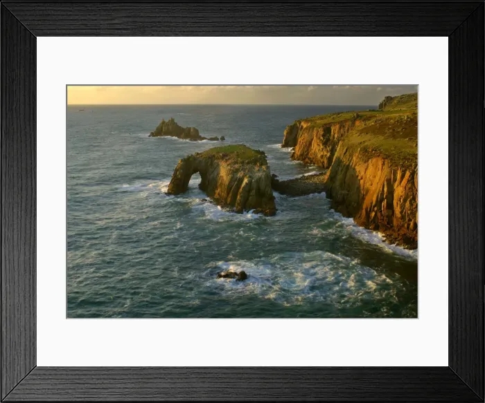 Framed Print : Lands End rugged coastline with rock arch in last evening light Lands End, Cornwall, England, UK Framed Print : Lands End rugged coastline with rock arch in last evening light Lands End, Cornwall, England, UK