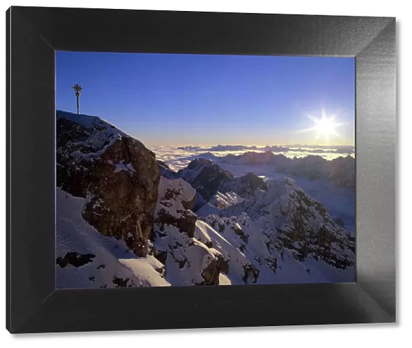 Sunrise on Zugspitze view from highest mountain of Germany with summit cross at sunrise Bavaria, Germany