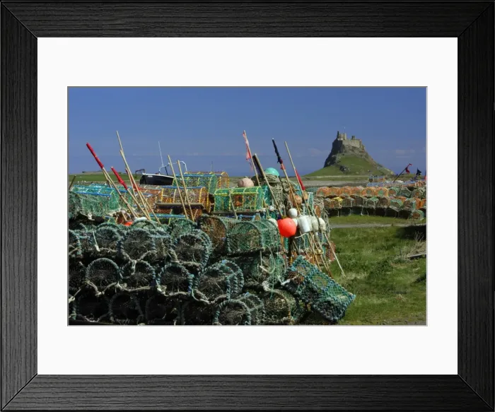 Framed Print : Lindisfarne, Holy Island-stacked lobster pots and view of castle, Northumberland UK Framed Print : Lindisfarne, Holy Island-stacked lobster pots and view of castle, Northumberland UK