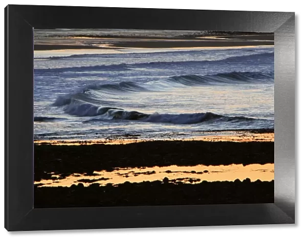 Waves-rolling on to beach at twilight, Northumberland UK