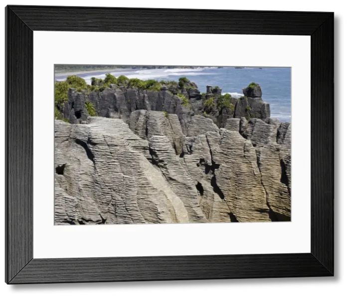 Framed Print : Limestone outcrops on cliffs. Punakaiki South Island - New Zealand. Pancake rocks form the main focus for visitors in Paparoa National Park where high outcrops of limestone have been formed by a process called stylobedding Framed Print : Limestone outcrops on cliffs. Punakaiki South Island - New Zealand. Pancake rocks form the main focus for visitors in Paparoa National Park where high outcrops of limestone have been formed by a process called stylobedding
