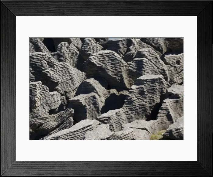 Framed Print : Limestone outcrops on cliffs. Punakaiki - South Island - New Zealand. Pancake rocks form the main focus for visitors in Paparoa National Park where huge outcrops of limestone have been formed by a process called stylobedding Framed Print : Limestone outcrops on cliffs. Punakaiki - South Island - New Zealand. Pancake rocks form the main focus for visitors in Paparoa National Park where huge outcrops of limestone have been formed by a process called stylobedding