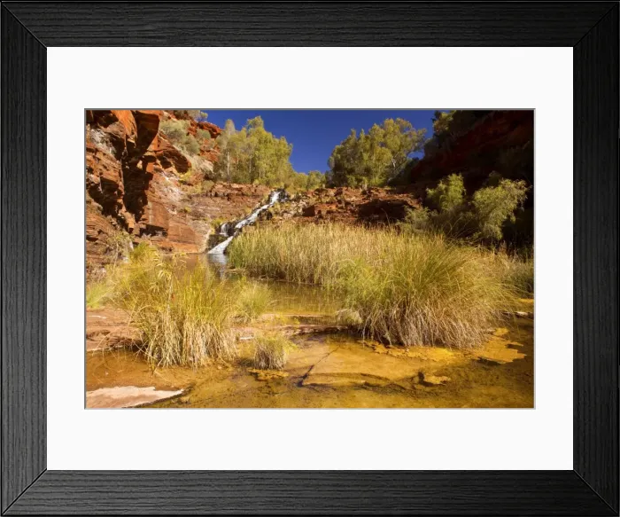 Framed Print : Fortescue Falls - water of a river tumbles down Fortescue Falls, the only permanent waterfall in Karijini National Park, and cascades into pools surrounded by vegetation Framed Print : Fortescue Falls - water of a river tumbles down Fortescue Falls, the only permanent waterfall in Karijini National Park, and cascades into pools surrounded by vegetation