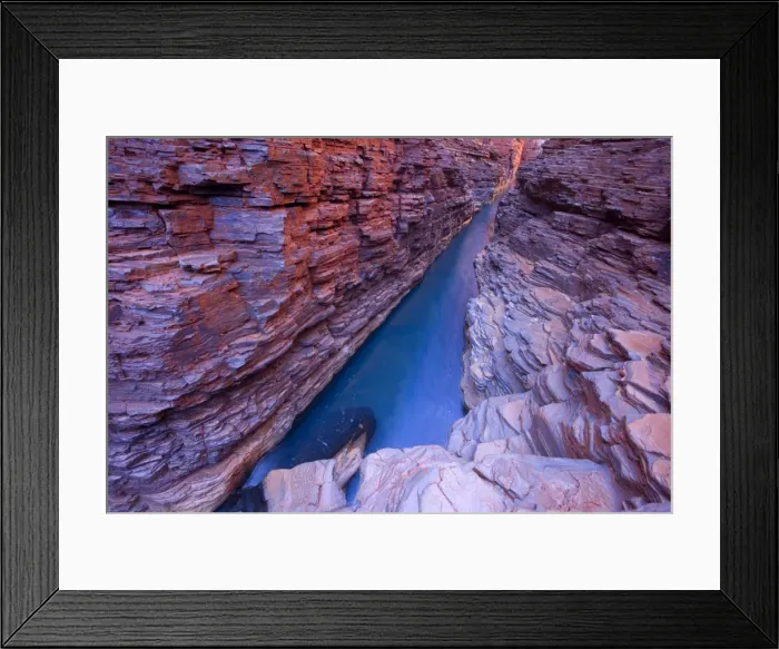 Framed Print : Hancock Gorge - a stream is flowing down Hancock Gorge, surrounded by steep, red and very terraced cliffs. At this section the stream is quite deep which is the reason why the water has such an amazing shade of blue - Hancock Gorge, Hamersley Range Framed Print : Hancock Gorge - a stream is flowing down Hancock Gorge, surrounded by steep, red and very terraced cliffs. At this section the stream is quite deep which is the reason why the water has such an amazing shade of blue - Hancock Gorge, Hamersley Range