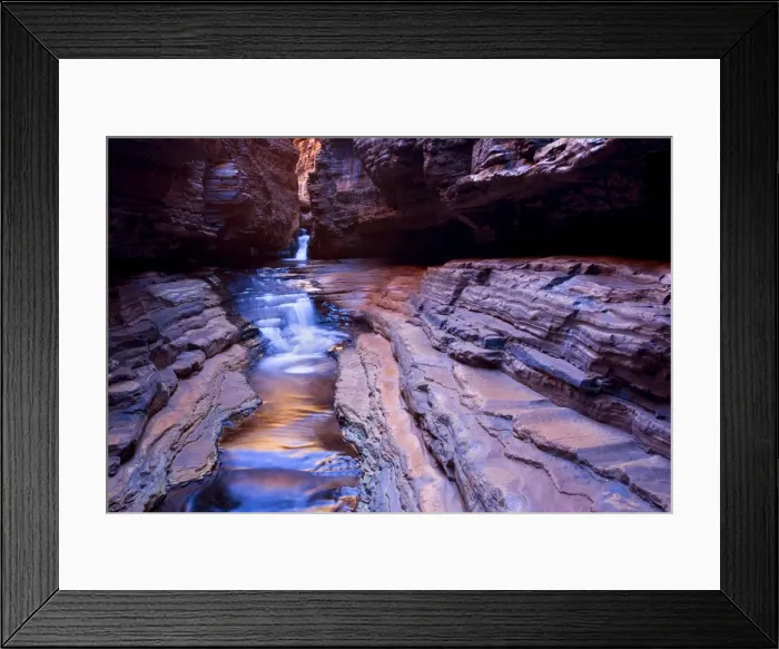 Framed Print : Hancock Gorge - a stream is flowing down Hancock Gorge, surrounded by steep, red and very terraced cliffs. The low water level exposes striated, highly polished and in different colour tones shining rock ledges Framed Print : Hancock Gorge - a stream is flowing down Hancock Gorge, surrounded by steep, red and very terraced cliffs. The low water level exposes striated, highly polished and in different colour tones shining rock ledges