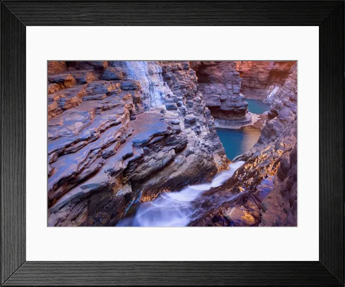 Framed Print : Hancock Gorge - water is flowing down a waterfall in Hancock Gorge into Raglan Pool and some further unaccessible pools beyond. They are surrounded by steep, red and very terraced cliffs Framed Print : Hancock Gorge - water is flowing down a waterfall in Hancock Gorge into Raglan Pool and some further unaccessible pools beyond. They are surrounded by steep, red and very terraced cliffs
