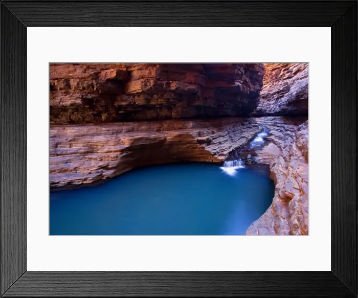Framed Print : Kermit's Pool - a stream is flowing down Hancock Gorge, surrounded by steep, red and very terraced ciffs, into Kermit's Pool. Because of it's depth the pool's water appears an amazing deep blue Framed Print : Kermit's Pool - a stream is flowing down Hancock Gorge, surrounded by steep, red and very terraced ciffs, into Kermit's Pool. Because of it's depth the pool's water appears an amazing deep blue