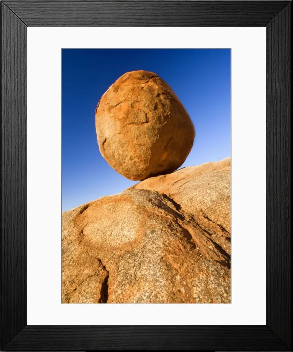 Framed Print : Devils Marbles - a nearly perfectly circular shaped boulder of red granite is balanced on bedrock. The Devils Marbles, also called Karlu Karlu in indigenous language Framed Print : Devils Marbles - a nearly perfectly circular shaped boulder of red granite is balanced on bedrock. The Devils Marbles, also called Karlu Karlu in indigenous language