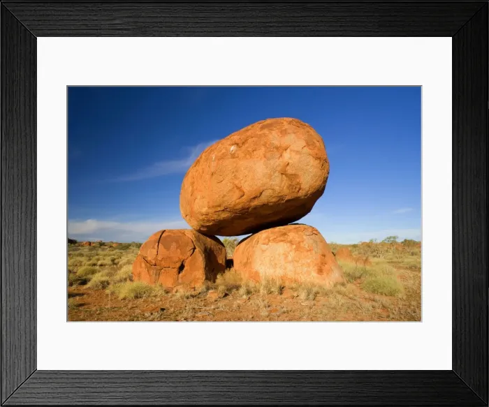 Framed Print : Devils Marbles - a balanced rock of red granite is situated on top of two boulders - Devils Marbles Conservation Area, Northern Territory, Australia Framed Print : Devils Marbles - a balanced rock of red granite is situated on top of two boulders - Devils Marbles Conservation Area, Northern Territory, Australia