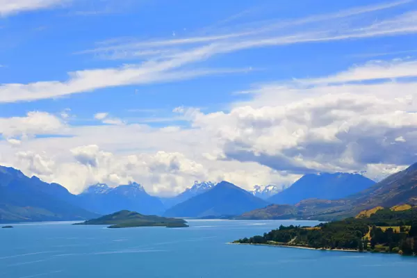 Lake Wakatipu view towards the stunning mountains of Mount Aspiring National Park with dispersing clouds after a heavy thunderstorm Queenstown, Otago, South Island, New Zealand