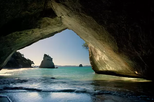 Cathedral Cove by erosion artfully sculpted rock formation seen from the inside of a natural rock arch at Cathedral Cove Cathedral Cove, Coromandel Peninsula, North Island, New Zealand