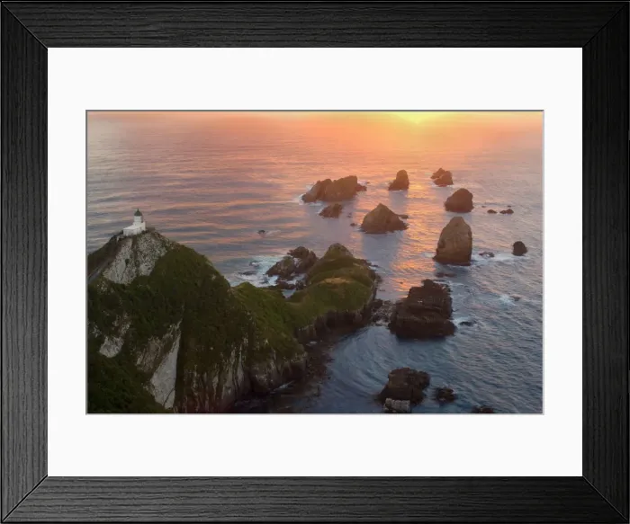Framed Print : Nugget Point sea stacks called nuggets and Nugget Point Lighthouse facing towards rising sun Catlins, Southland, South Island, New Zealand Framed Print : Nugget Point sea stacks called nuggets and Nugget Point Lighthouse facing towards rising sun Catlins, Southland, South Island, New Zealand