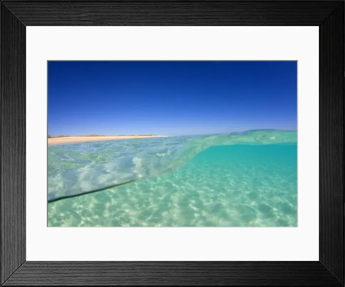 Framed Print : Sand ripples - over and under water shot of a sun drenched ocean. The sunlight reflects on the waves and throws light and shadow on the sand rippled ground Framed Print : Sand ripples - over and under water shot of a sun drenched ocean. The sunlight reflects on the waves and throws light and shadow on the sand rippled ground