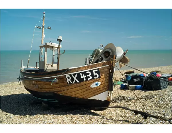 Trawler Boat. The beach at Dungeness looks like a dumping ground, but geologists are fascinated by the action of wind and tide, on this extreme corner of Kent. Fishermen are here because the sea near the shingle beach is exceptionally deep