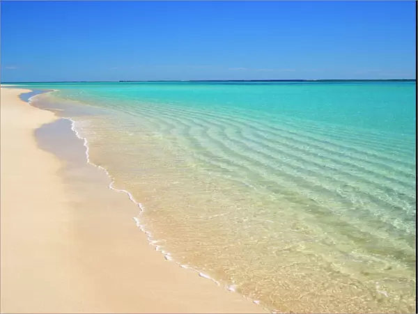 Dream Beach - white sandy beach, clear turquoise coloured water and a deep blue sky combine to a perfect beach. Through the clear water sand ripples, created by a gentle surf, are visible - Ningaloo Reef Marine Park, Western Australia, Australia