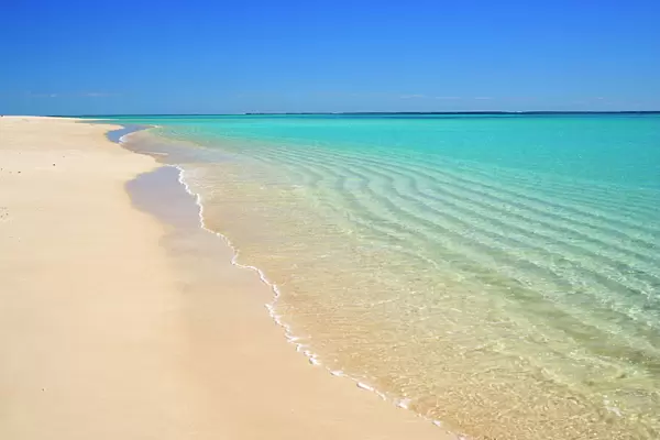 Dream Beach - white sandy beach, clear turquoise coloured water and a deep blue sky combine to a perfect beach. Through the clear water sand ripples, created by a gentle surf, are visible - Ningaloo Reef Marine Park, Western Australia, Australia