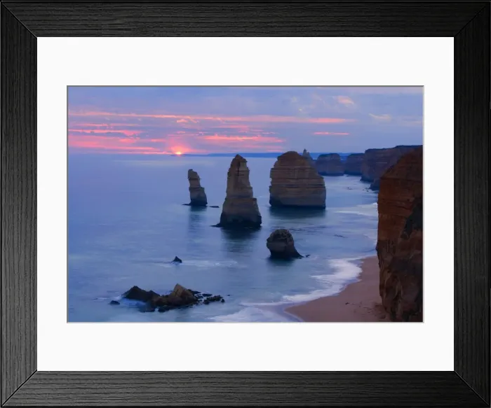 Framed Print : Twelve Apostles sunset - setting sun over the sandstone rock formations of famous Twelve Apostels, which are sculpted by the relentless sea. The force of the sea eats more and more of the rocks away and finally forces them to collapse Framed Print : Twelve Apostles sunset - setting sun over the sandstone rock formations of famous Twelve Apostels, which are sculpted by the relentless sea. The force of the sea eats more and more of the rocks away and finally forces them to collapse