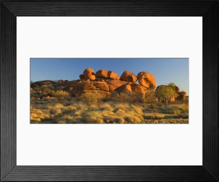 Framed Print : Devils Marbles - several circular shaped marbles of red granite are balanced on top of a hugh rock in last evening light. The whole rock formation is situated amidst grassy bushland - Devils Marbles Conservation Area, Northern Territory, Australia Framed Print : Devils Marbles - several circular shaped marbles of red granite are balanced on top of a hugh rock in last evening light. The whole rock formation is situated amidst grassy bushland - Devils Marbles Conservation Area, Northern Territory, Australia