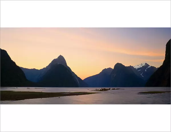 Milford Sound with landmark Mitre Peak and surrounding mountains just after sunset. Milford Sound is one of the, if not THE, most famous attraction in New Zealand