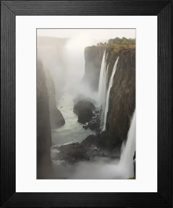 Framed Print : Zambia - View of the Zambezi River and the Victoria Falls (1700m wide). The image show the Rainbow Falls (108m, highest falls). At dawn in early August during the dry season Framed Print : Zambia - View of the Zambezi River and the Victoria Falls (1700m wide). The image show the Rainbow Falls (108m, highest falls). At dawn in early August during the dry season