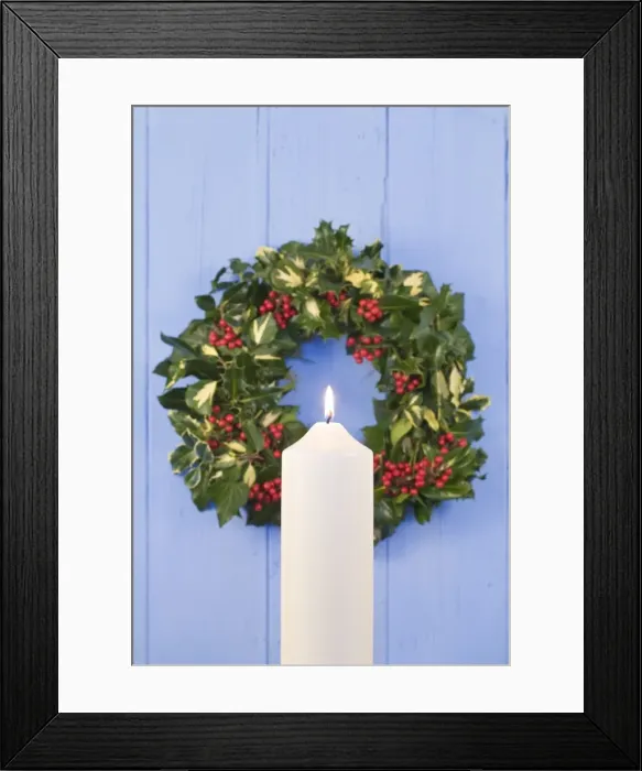 Framed Print : Christmas Wreath on old wooden door with white candle Framed Print : Christmas Wreath on old wooden door with white candle