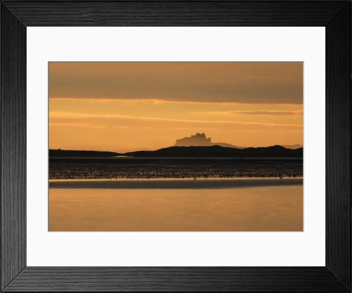 Framed Print : View of Bamburgh Castle - from Holy Island causeway at dawn, Lindisfarne National Nature Reserve, Northumberland, England
