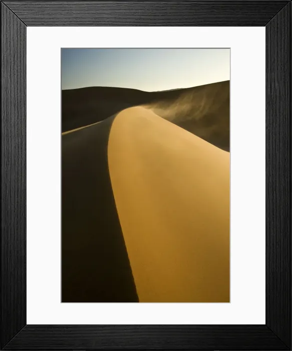 Framed Print : Dunes in late afternoon light - with sand blowing over the crest in a smoke stack - Dune Fields - Namib Desert - Namibia - Africa Framed Print : Dunes in late afternoon light - with sand blowing over the crest in a smoke stack - Dune Fields - Namib Desert - Namibia - Africa