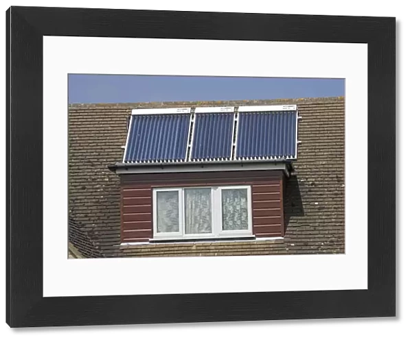Modern solar panels on roof of detached house Cotswolds UK