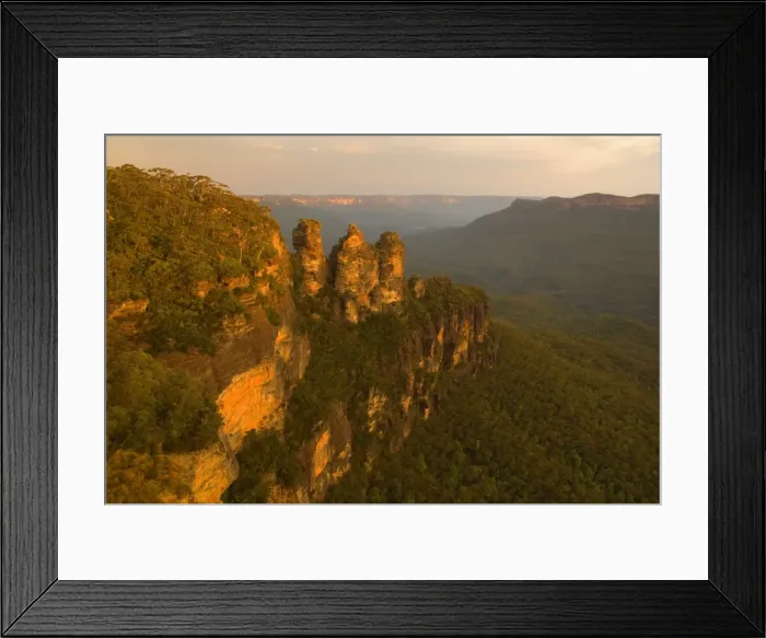 Framed Print : The Three Sisters - famous sandstone formations Three Sisters, seen from Echo Lookout, at sunset. The low sun plunges the scenery in exquisite red light - Blue Mountains National Park, New South Wales, Australia Framed Print : The Three Sisters - famous sandstone formations Three Sisters, seen from Echo Lookout, at sunset. The low sun plunges the scenery in exquisite red light - Blue Mountains National Park, New South Wales, Australia