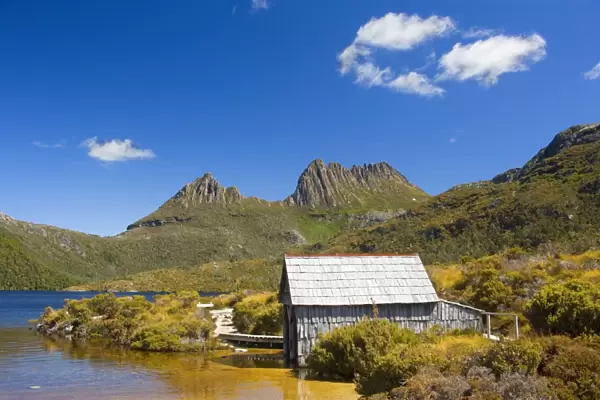 Mountain scenery - stunning Dove Lake in front of massive Cradle Mountain is one of Tasmania's most beautiful and famous natural features. A rustic boat shed gives a romantic touch - Cradle Mountain-Lake St