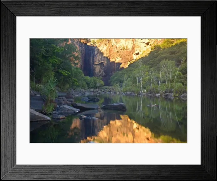 Framed Print : Jim Jim Falls - water of famous Jim Jim Falls plunges down into a deep pool surrounded by spectacular 150 m high cliffs. Red cliffs and monsoon forest reflect in a pond's calm water Framed Print : Jim Jim Falls - water of famous Jim Jim Falls plunges down into a deep pool surrounded by spectacular 150 m high cliffs. Red cliffs and monsoon forest reflect in a pond's calm water