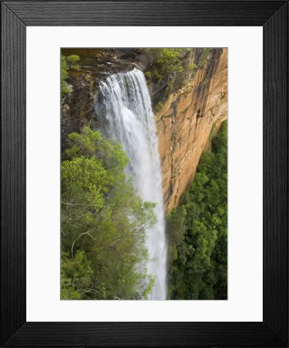 Framed Print : Tianjara Falls - view of stunning waterfall rushing over a red cliff from above. It plunges into a deep gorge, surrounded by lush forest - Moreton National Park, New South Wales, Australia Framed Print : Tianjara Falls - view of stunning waterfall rushing over a red cliff from above. It plunges into a deep gorge, surrounded by lush forest - Moreton National Park, New South Wales, Australia
