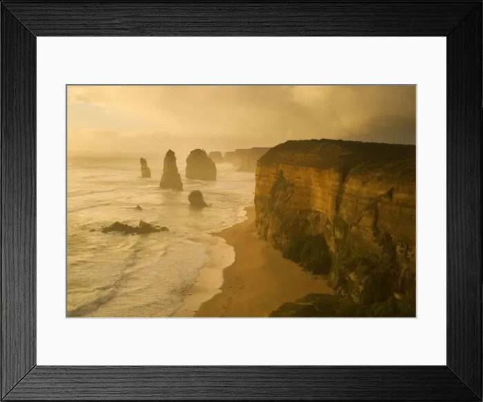 Framed Print : Twelve Apostles - a storm is brewing over the coastline and fragile sandstone stacks of the Twelve Apostles. The low sun is able to cut through a hole in the thick clouds and casts an eerie yellow light onto the cliffs, the ocean and the sky Framed Print : Twelve Apostles - a storm is brewing over the coastline and fragile sandstone stacks of the Twelve Apostles. The low sun is able to cut through a hole in the thick clouds and casts an eerie yellow light onto the cliffs, the ocean and the sky
