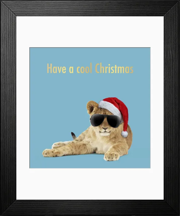 Framed Print : 13131723. Lion cub (approx 16 weeks old) laying wearing Christmas hat and sunglasses Date Framed Print : 13131723. Lion cub (approx 16 weeks old) laying wearing Christmas hat and sunglasses Date